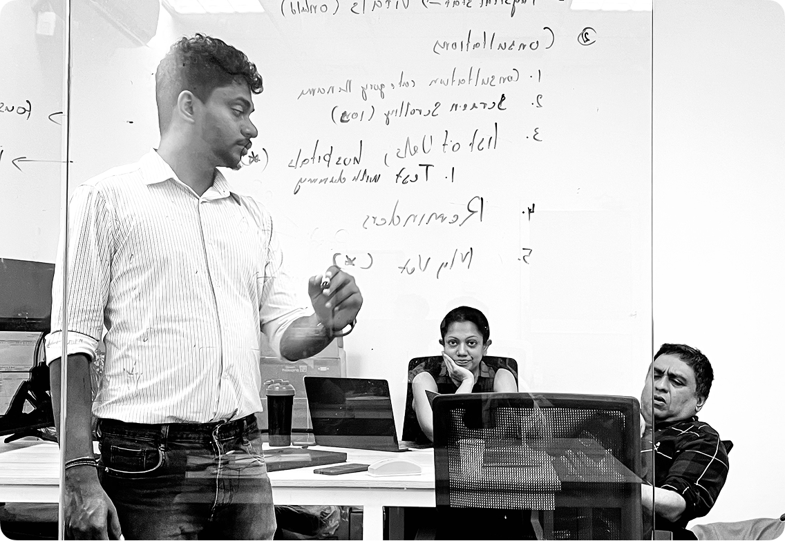 Upview team members collaborating at a whiteboard during an office meeting